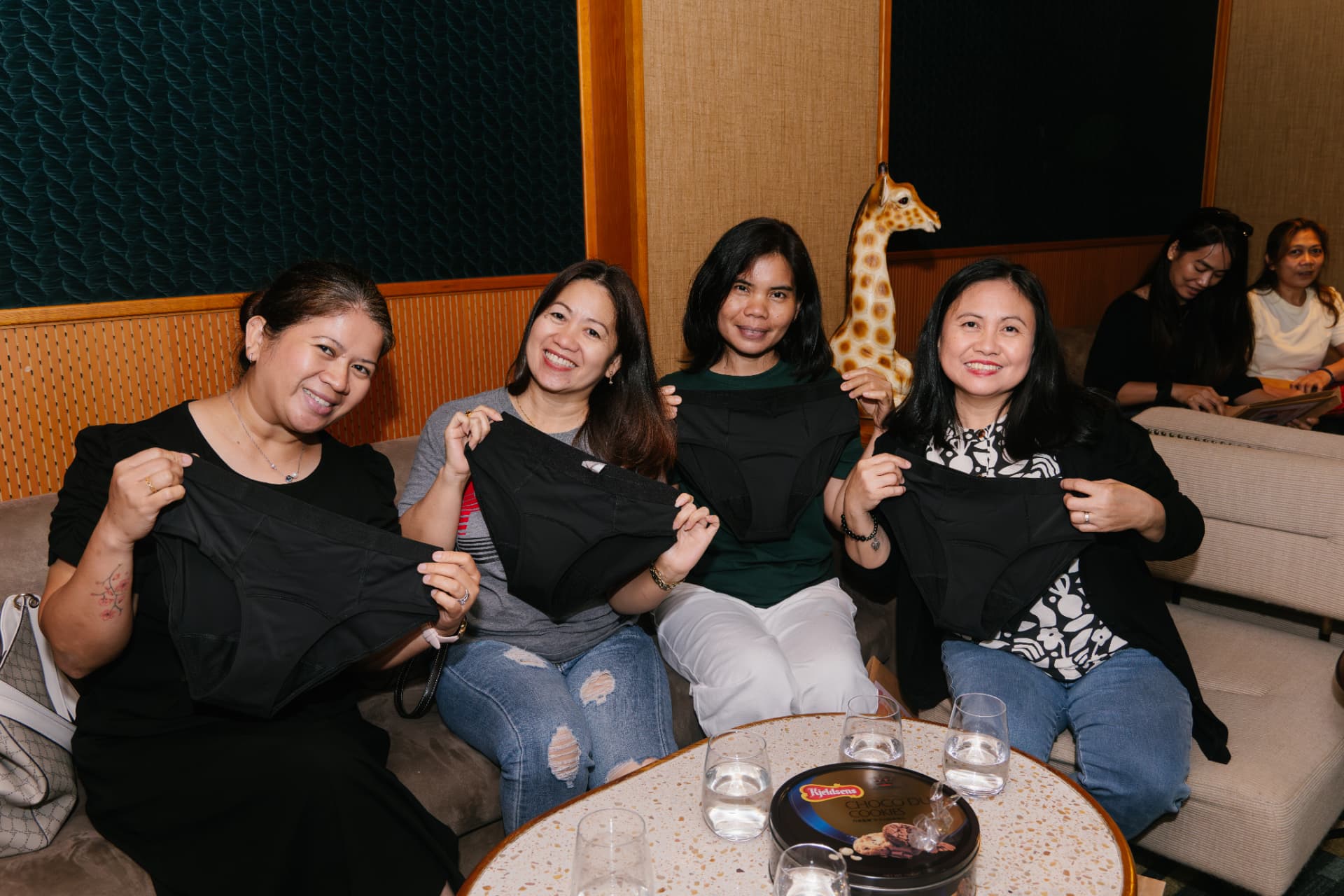 Four community participants holding reusable period underwear